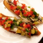 Antxoas con jardinera Anchovies with a salsa of red and green peppers, guindillas and onion